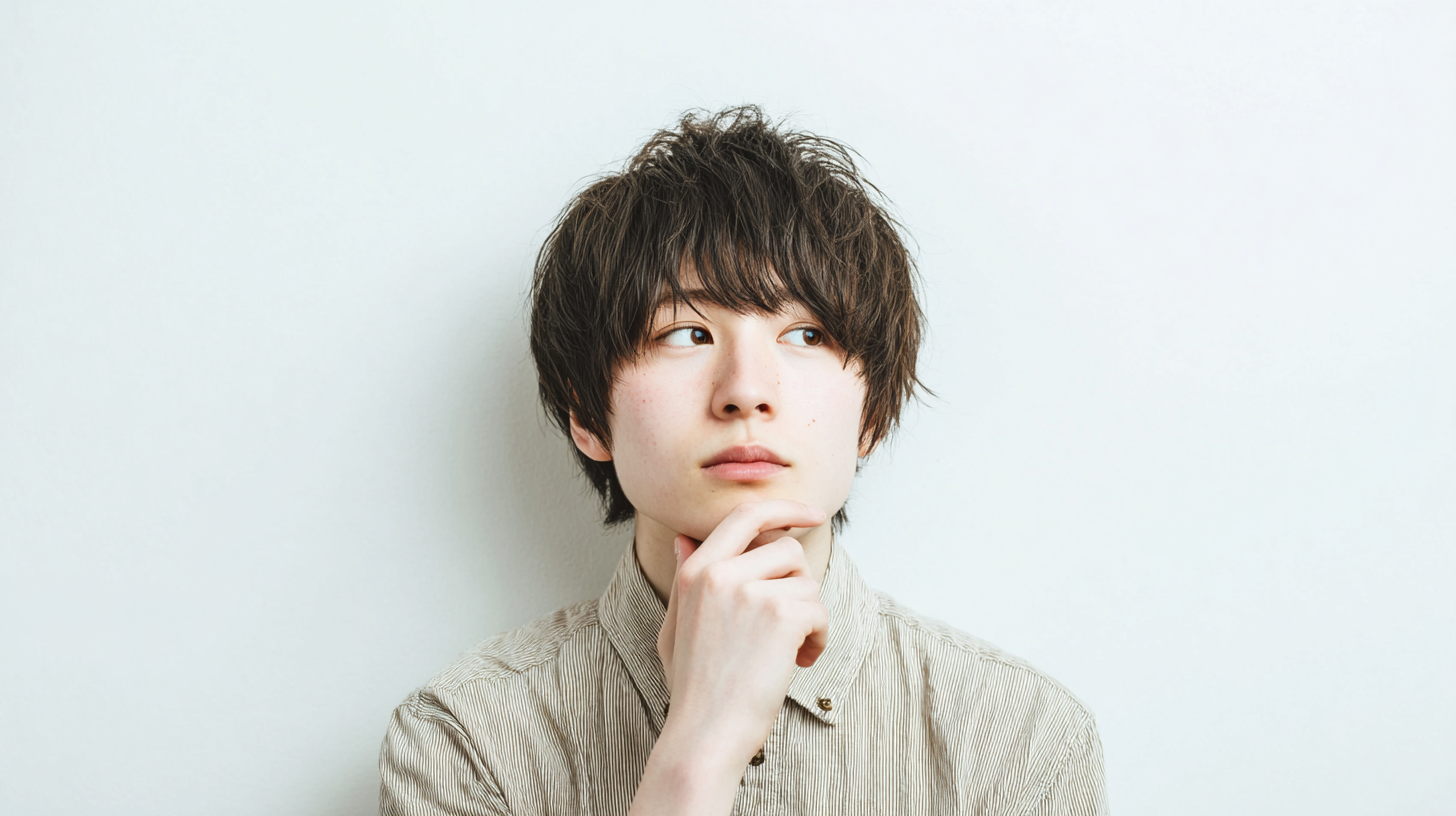 考えている男の画像